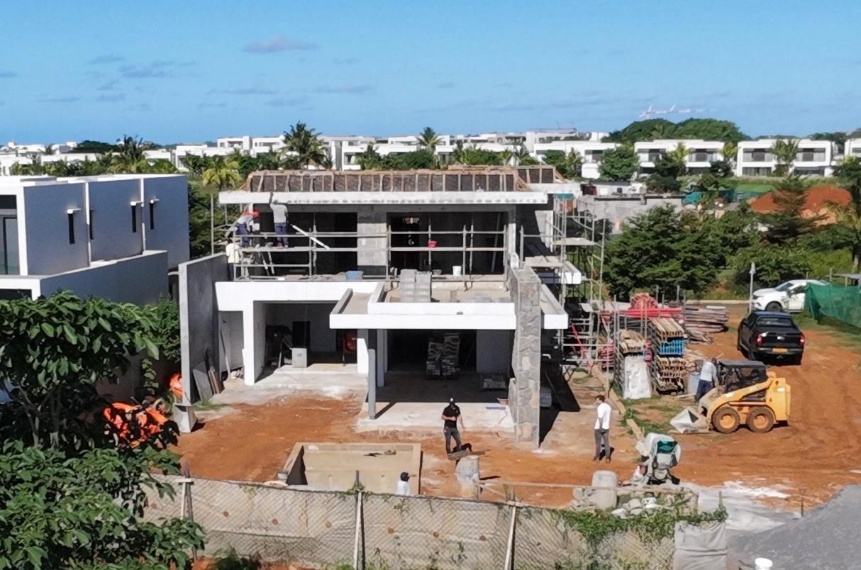 Two-storey villa under construction with scaffolding
