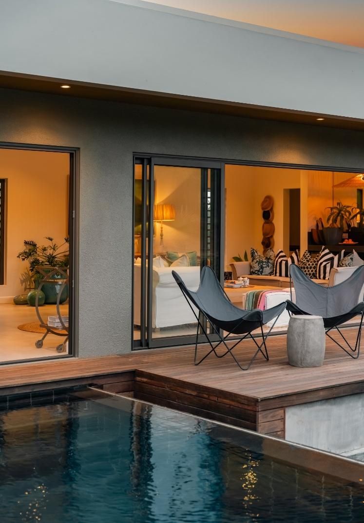 Covered terrace with sliding glass doors at dusk